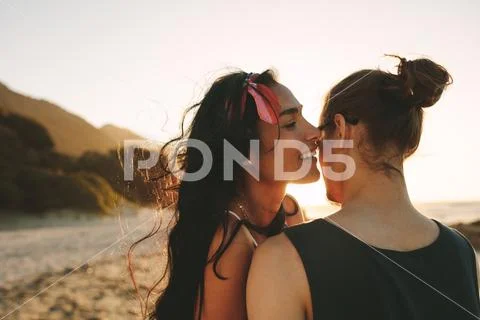 She whispered sweet nothings in his ear Stock Photos