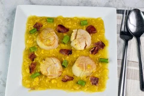 Sheared scallops with bacon ,cream corn and  green onions Stock Photos