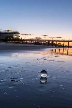 Sheen on the sand makes double. Stock Photos