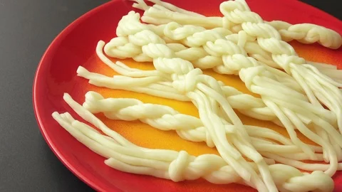 Sheep's milk cheese on a red plate. Delicious cheese. Special cheese. Stock Footage 90842589