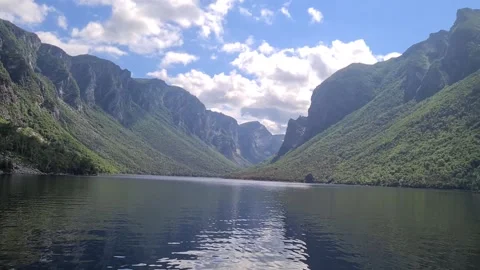Sheer cliffs reflecting in Western Brook Pond fjord, Gros Morne National Park Stock Footage 346368404