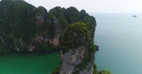 Sheer karst cliffs above a deep green channel in Thailand Stock-Footage 71298075