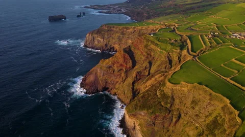 Sheer Volcanic Cliffs With Patchwork Fields at Sunset - São Miguel Island - Stock Footage 339784709