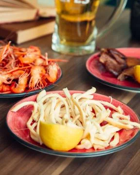 Сheese pigtail served with lemon Stock Photos
