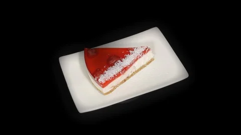 Сheesecake in the spinning table isolated on black background in white plate Stock-Footage 104721813
