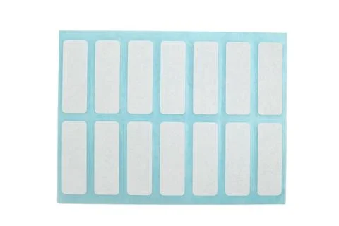 Sheet of blank white rectangular adhesive stickers on blue backing paper. S.. Fotos Stock
