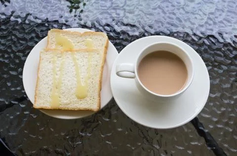 Sheet bread and a cup of coffee on table Stock Photos