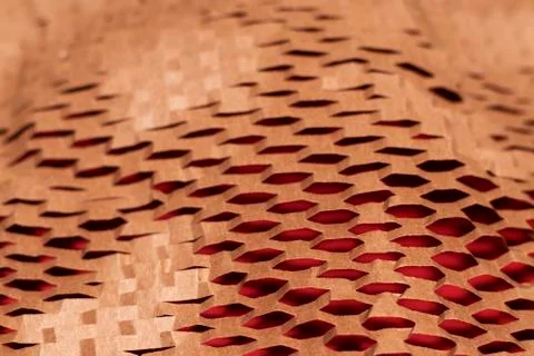 A sheet of cut paper pattern texture on a red background Stock Photos