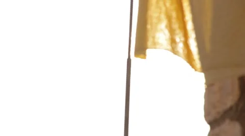 Sheet dancing on wind with sun leaks in background Stock Footage 49133759