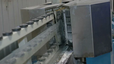 A sheet of glass coming out of the machine for processing the edges. Factory for Video stock 85655839