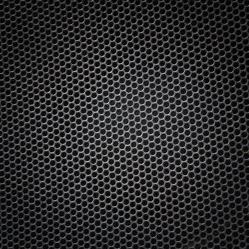 Sheet of metal covered with lines of circular holes Stock Photos