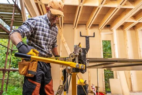 Sheet Metal Folding Machine Operating by Construction Worker Stock Photos