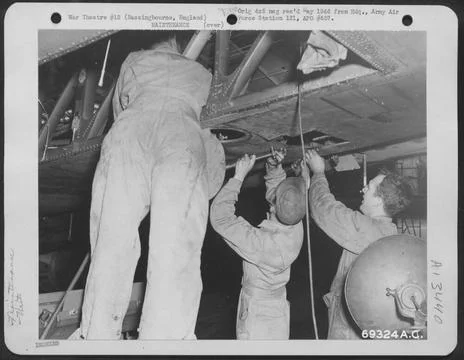 Sheet Metal Workers Patch The Underside Of A Boeing B-17 Flying Fortress W... Stock Photos