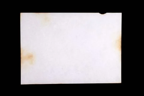 Sheet of old paper with multiple damage from fire and time, isolated on black Stock Photos