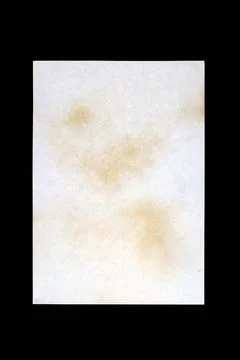 Sheet of old paper with multiple damage from fire and time, isolated on black Stock Photos