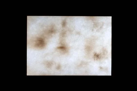 Sheet of old paper with multiple damage from fire and time, isolated on black Stock Photos