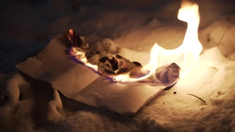 Sheet of paper burns to ashes on snow Stock Footage 316081720