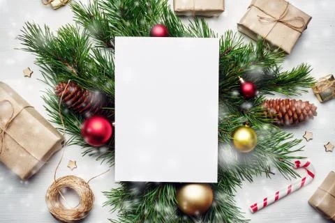 Sheet of paper with copy space on New Year toys and branches of a Christmas t Stock Photos