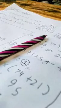 A sheet of paper filled with handwritten math problems and calculations 스톡 사진