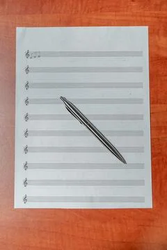 A sheet of paper with notes. Women's hands on a sheet of sheet music Stock Photos