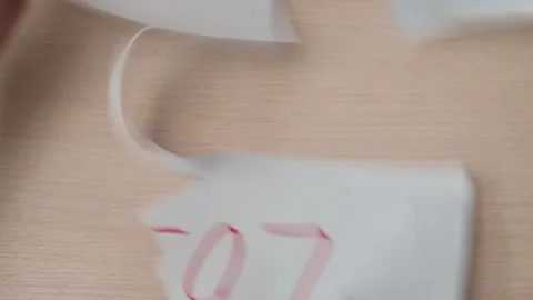 A sheet of paper with the word loss written in red is crumpled and torn by hands 스톡 동영상 337550861