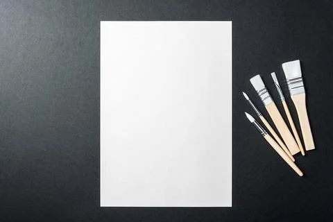 The sheet is pure white and the paint brushes are on a black background with  Stock Photos