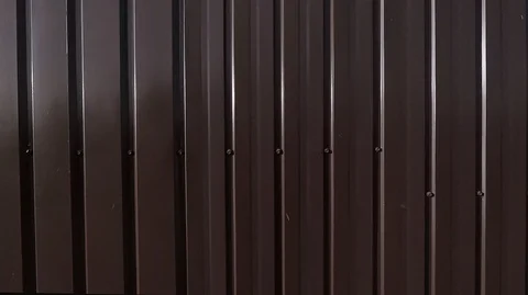 A sheet of thin bent in the form of vertical strips of metal Stock Footage 124738487