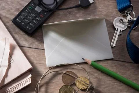 A sheet for writing on a table surrounded by objects of daily use. Stock Photos