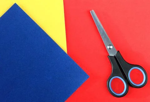 Sheets of colored paper and scissors with copy space. Stock Photos