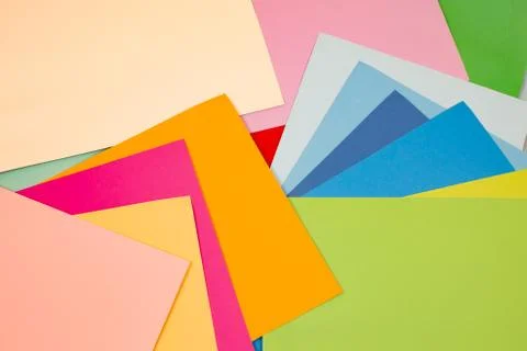 Sheets of colored paper. Many colored sheets of paper are laid out in the har Foto stock