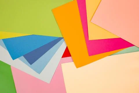 Sheets of colored paper. Many colored sheets of paper are laid out in the har Stock Photos
