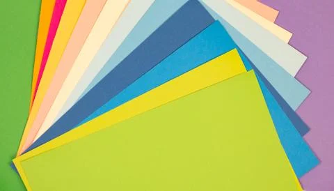 Sheets of colored paper. Many colored sheets of paper are laid out in the har Stock Photos