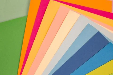 Sheets of colored paper. Many colored sheets of paper are laid out in the har Stock Photos