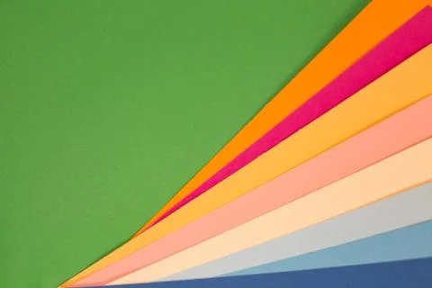 Sheets of colored paper. Many colored sheets of paper are laid out in the har Stock Photos