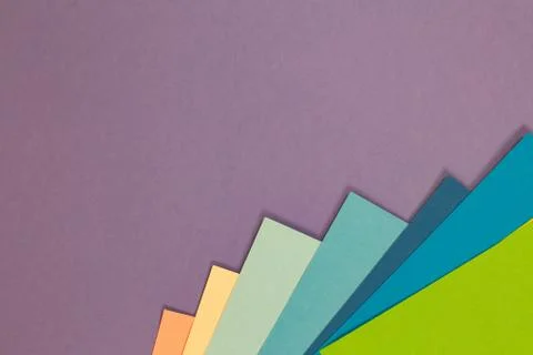 Sheets of colored paper. Many colored sheets of paper are laid out in the har Stock Photos