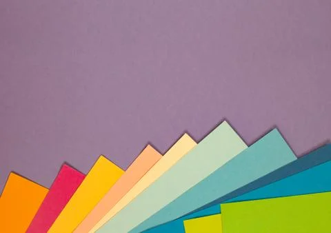 Sheets of colored paper. Many colored sheets of paper are laid out in the har Stock Photos