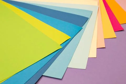 Sheets of colored paper. Many colored sheets of paper are laid out in the har Stock Photos