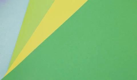 Sheets of colored paper. Many colored sheets of paper are laid out in the har 库存照片
