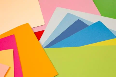 Sheets of colored paper. Many colored sheets of paper are laid out in the har Stock Photos
