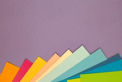 Sheets of colored paper. Many colored sheets of paper are laid out in the har Foto stock