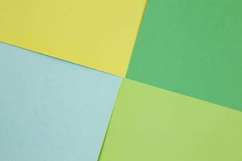 Sheets of colored paper. Many colored sheets of paper are laid out in the harsh Stock Photos
