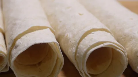 Sheets of fresh, thin pita bread rolled into tubes. Shooting parallax from .. Stock Footage 310157068