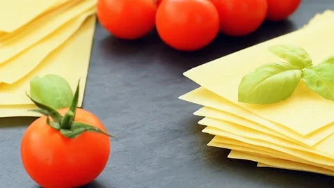 Sheets of lasagna with cherry tomatoes Video stock 71346334