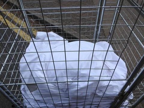 Sheets in a laundry cage Stock Photos