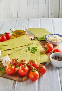 Sheets for making lasagna with spinach and ingredients: cherry tomatoes, chee Stock Photos