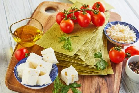 Sheets for making lasagna with spinach and ingredients: cherry tomatoes, chee Stock Photos
