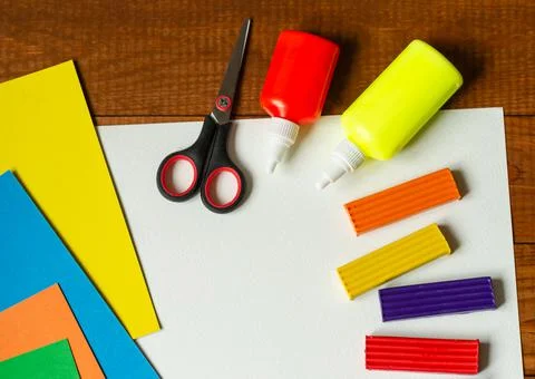 Sheets of paper, glue and scissors on a wooden table. Children's art project, Stock Photos