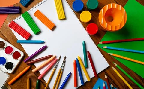 Sheets of paper, glue and scissors on a wooden table. Children's art project, a Stock Photos