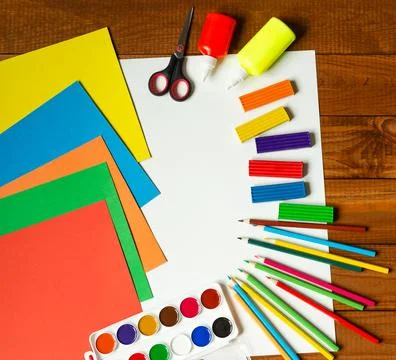 Sheets of paper, glue and scissors on a wooden table. Children's art project, a Stock Photos