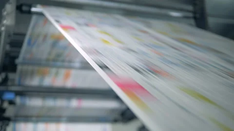 Sheets rolling on an automated conveyor at a print office. Stock Footage 107457800